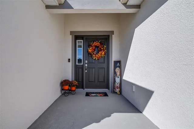 a living room with furniture and a baby crib