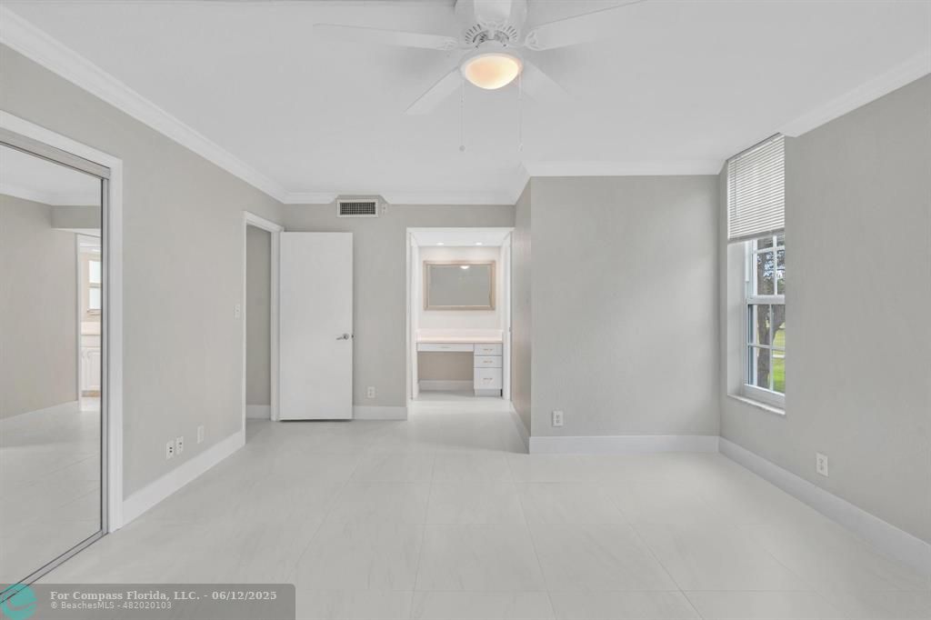 3800 Oaks Clubhouse Drive, Unit 201 Pompano Beach, FL 33069 - Photo 11 of 29 a view of an empty room with a window