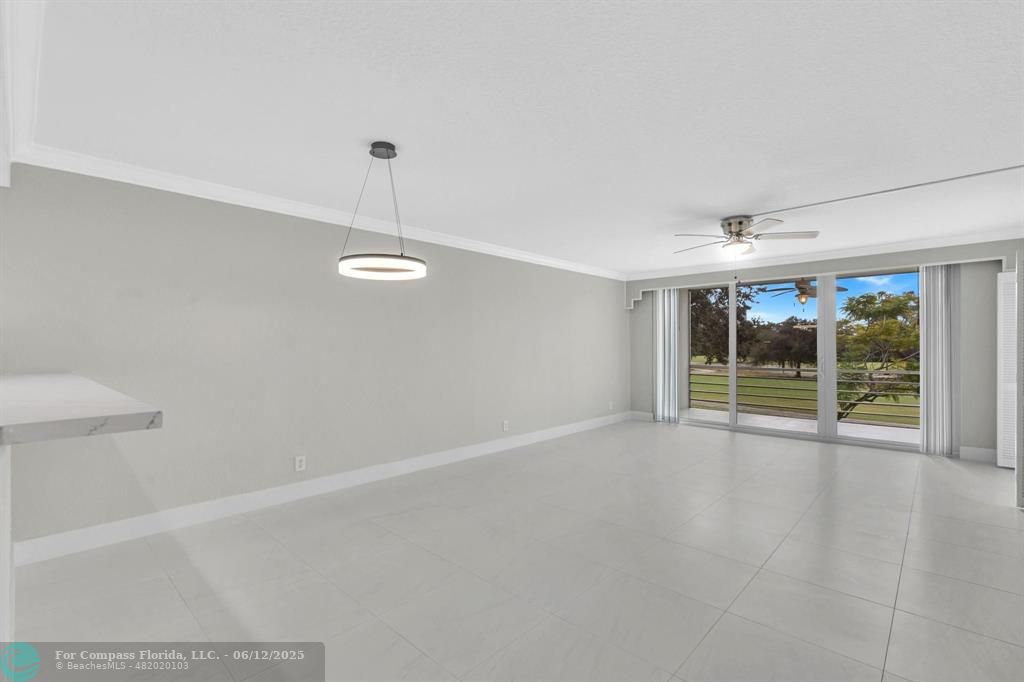 3800 Oaks Clubhouse Drive, Unit 201 Pompano Beach, FL 33069 - Photo 12 of 29 a view of an empty room with windows