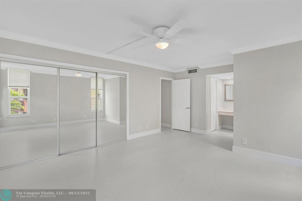 3800 Oaks Clubhouse Drive, Unit 201 Pompano Beach, FL 33069 - Photo 13 of 29 a view of an empty room with a window