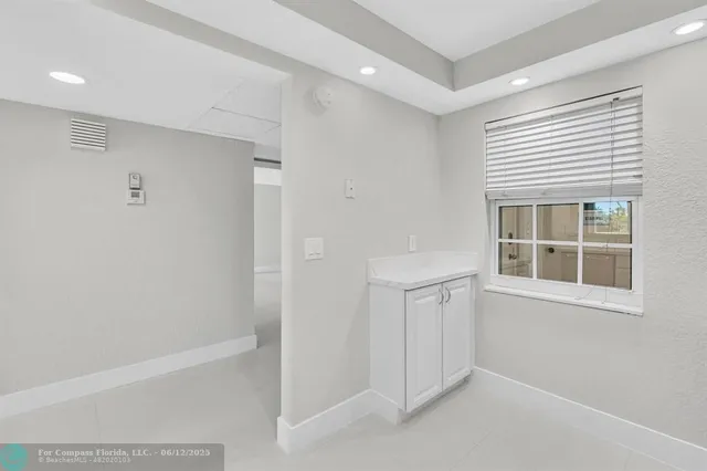 a view of an empty room with a window