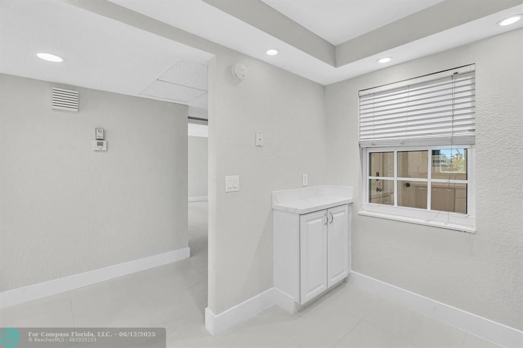 3800 Oaks Clubhouse Drive, Unit 201 Pompano Beach, FL 33069 - Photo 14 of 29 a view of an empty room with a window