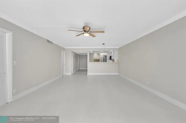 a view of a livingroom with a ceiling fan and couch