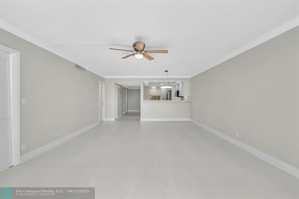 3800 Oaks Clubhouse Drive, Unit 201 Pompano Beach, FL 33069 - Photo 15 of 29 a view of a livingroom with a ceiling fan and couch