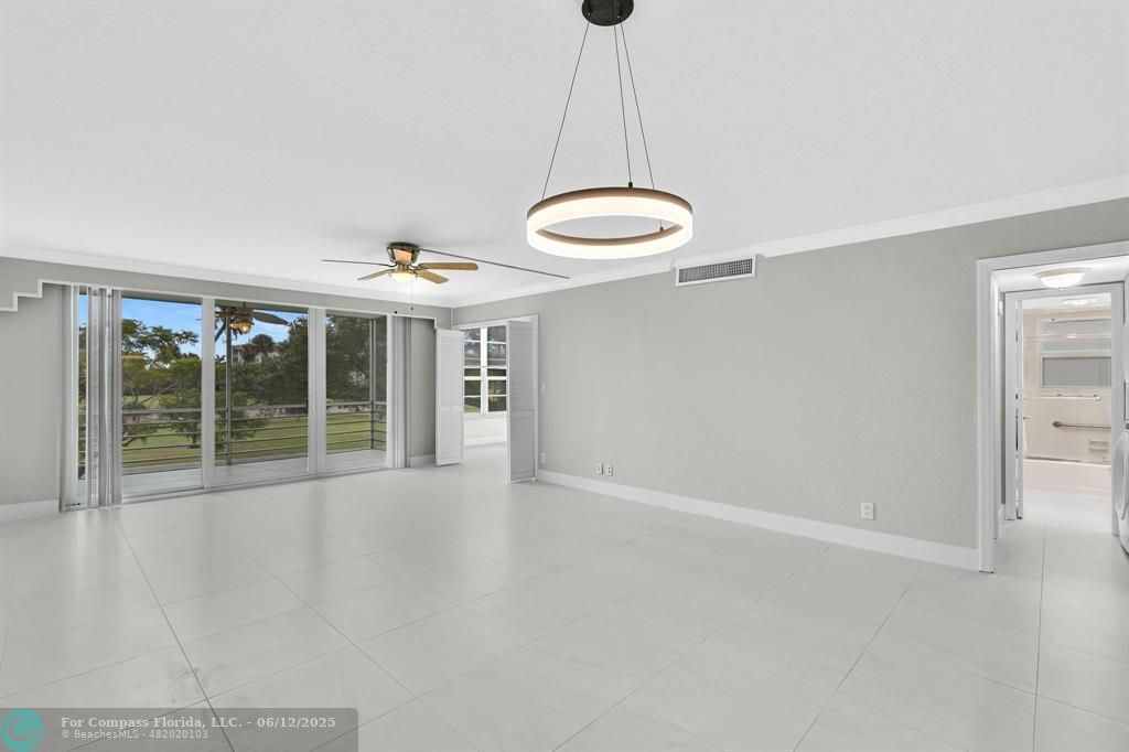 3800 Oaks Clubhouse Drive, Unit 201 Pompano Beach, FL 33069 - Photo 16 of 29 a view of an empty room with a window