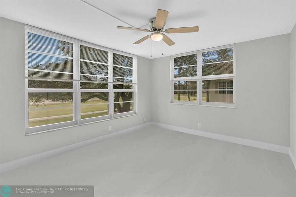 3800 Oaks Clubhouse Drive, Unit 201 Pompano Beach, FL 33069 - Photo 19 of 29 a view of an empty room with a window