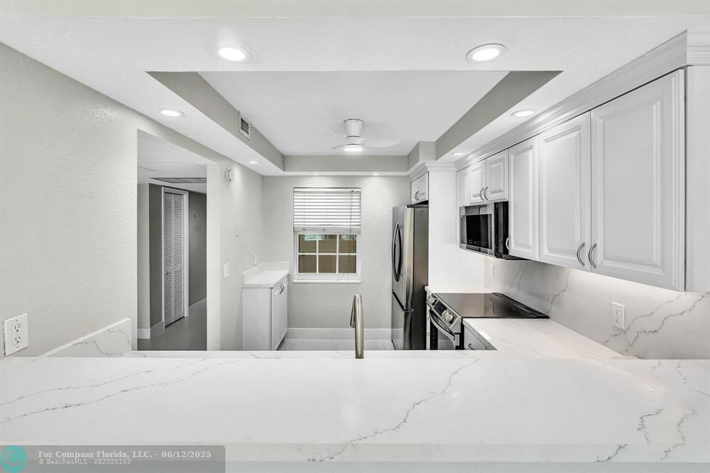 3800 Oaks Clubhouse Drive, Unit 201 Pompano Beach, FL 33069 - Photo 21 of 29 a bedroom with a bed closet and glass door