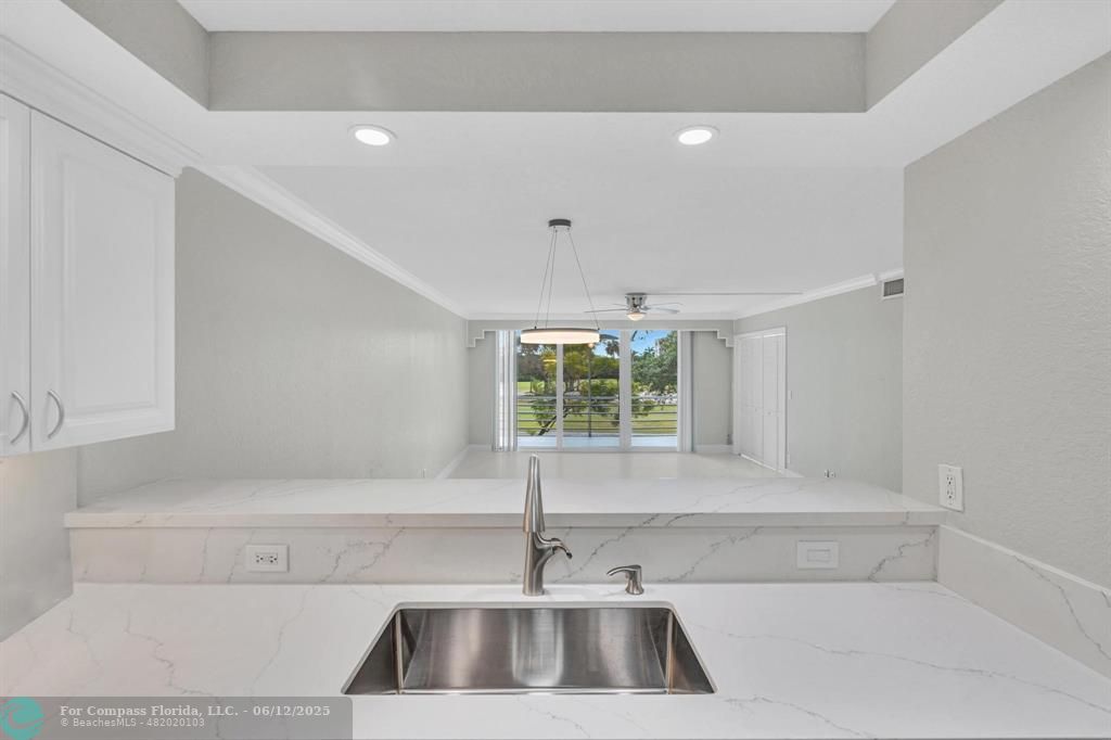3800 Oaks Clubhouse Drive, Unit 201 Pompano Beach, FL 33069 - Photo 24 of 29 a view of a sink and a window