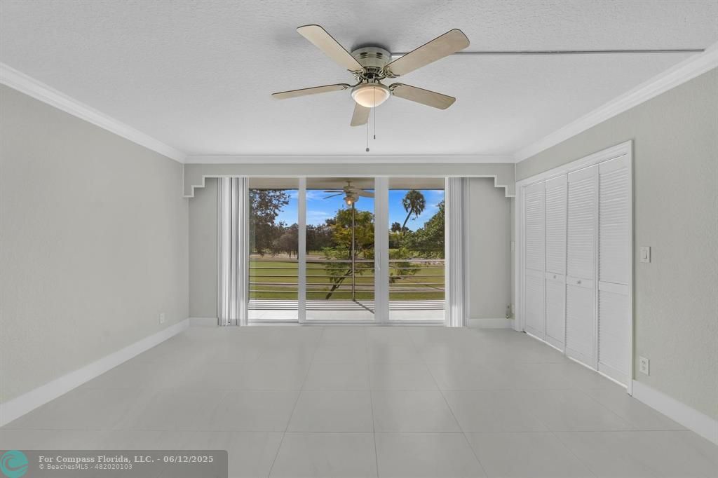 3800 Oaks Clubhouse Drive, Unit 201 Pompano Beach, FL 33069 - Photo 25 of 29 a view of an empty room with a window