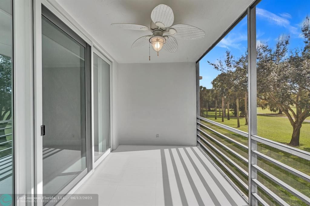 3800 Oaks Clubhouse Drive, Unit 201 Pompano Beach, FL 33069 - Photo 28 of 29 a view of a room with a large window