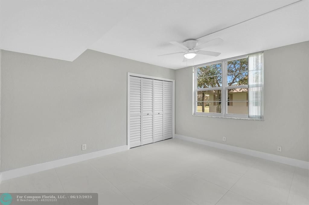 3800 Oaks Clubhouse Drive, Unit 201 Pompano Beach, FL 33069 - Photo 29 of 29 an empty room with windows