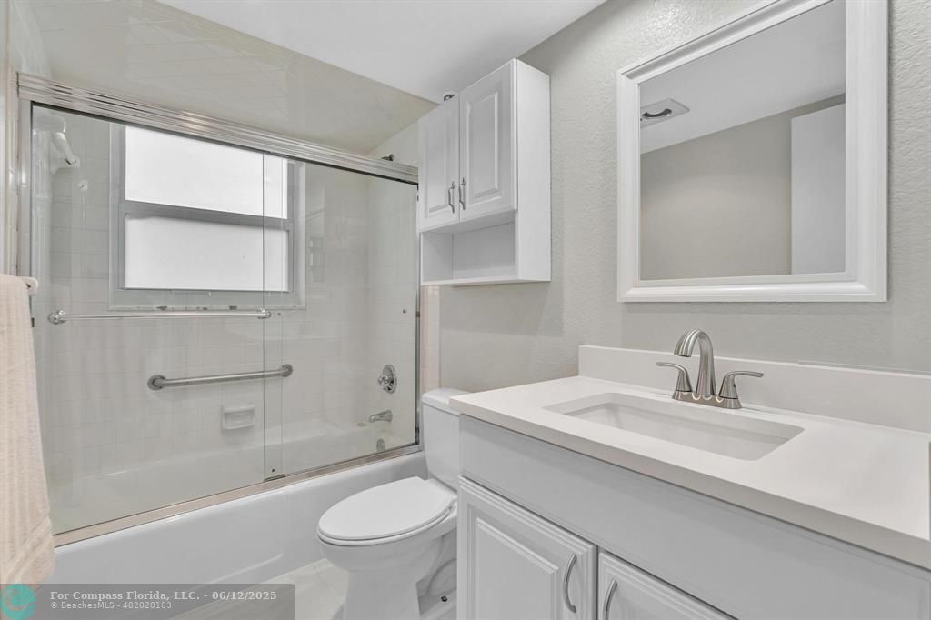 3800 Oaks Clubhouse Drive, Unit 201 Pompano Beach, FL 33069 - Photo 5 of 29 a bathroom with a sink a toilet and shower