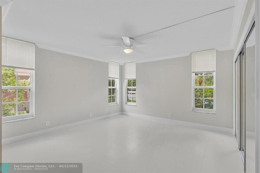 3800 Oaks Clubhouse Drive, Unit 201 Pompano Beach, FL 33069 - Photo 7 of 29 an empty room with windows and closet