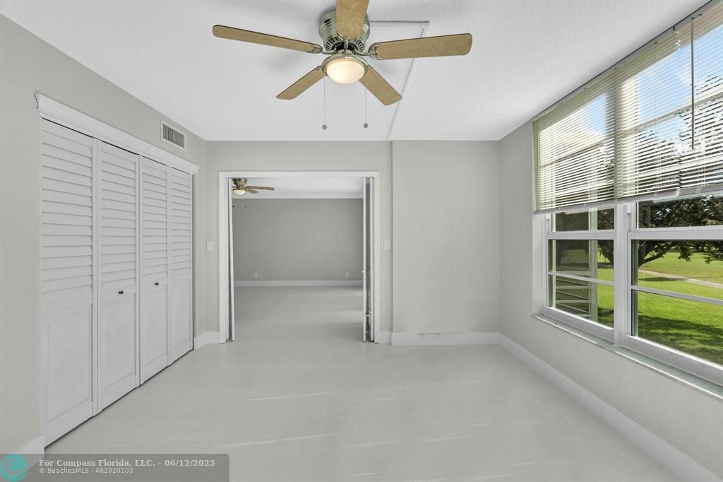 3800 Oaks Clubhouse Drive, Unit 201 Pompano Beach, FL 33069 - Photo 8 of 29 an empty room with windows and closet