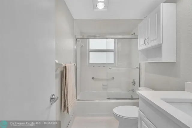 a bathroom with a toilet a sink and bathtub