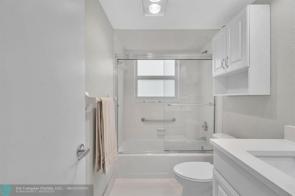 3800 Oaks Clubhouse Drive, Unit 201 Pompano Beach, FL 33069 - Photo 10 of 29 a bathroom with a toilet a sink and bathtub