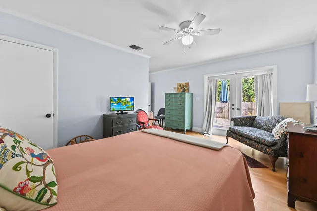 a bedroom with a bed and a chandelier