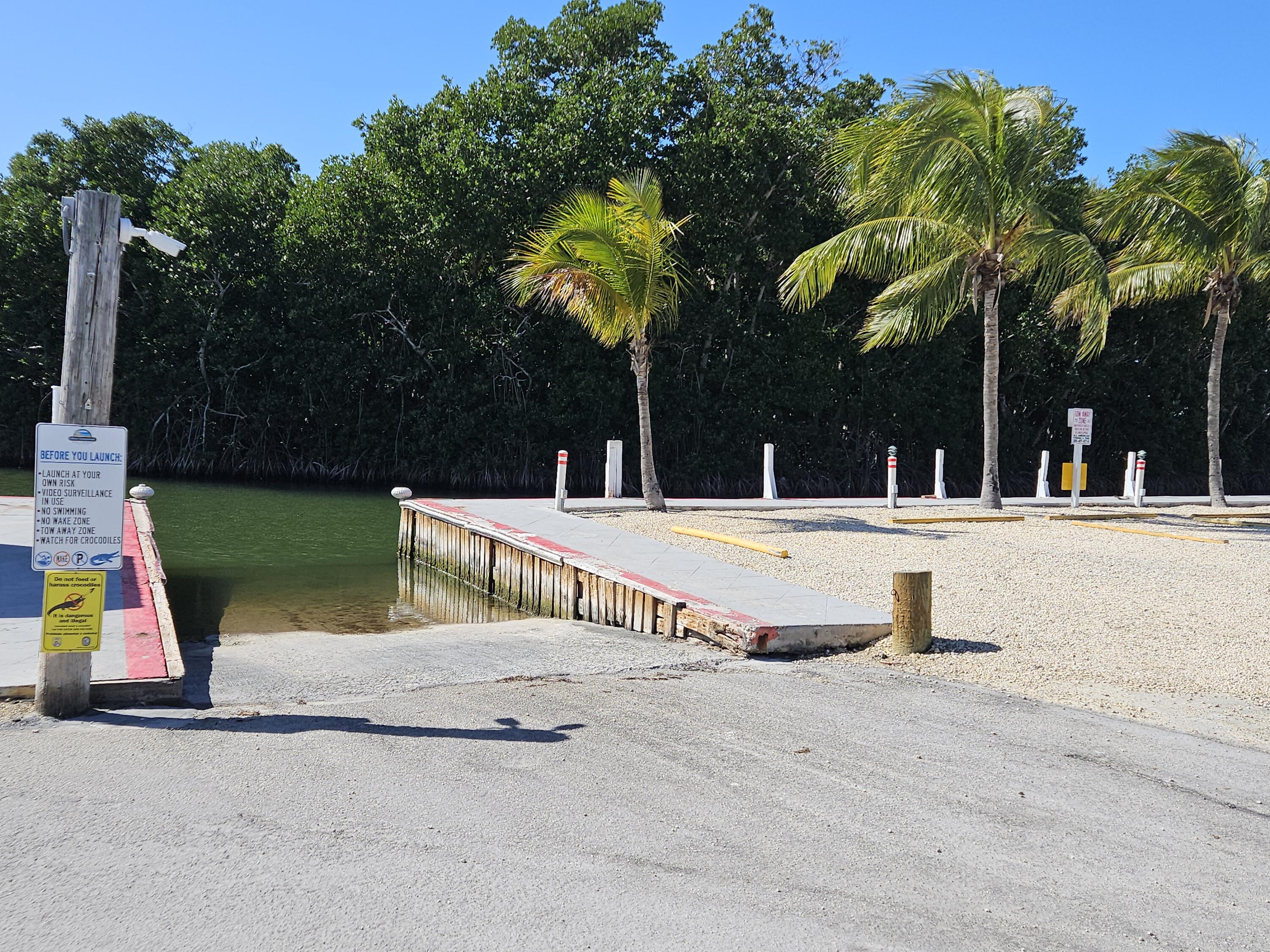 325 Calusa Street, Unit 245 Key Largo, FL 33037 - Photo 40 of 48 a view of swimming pool with a slide and yard