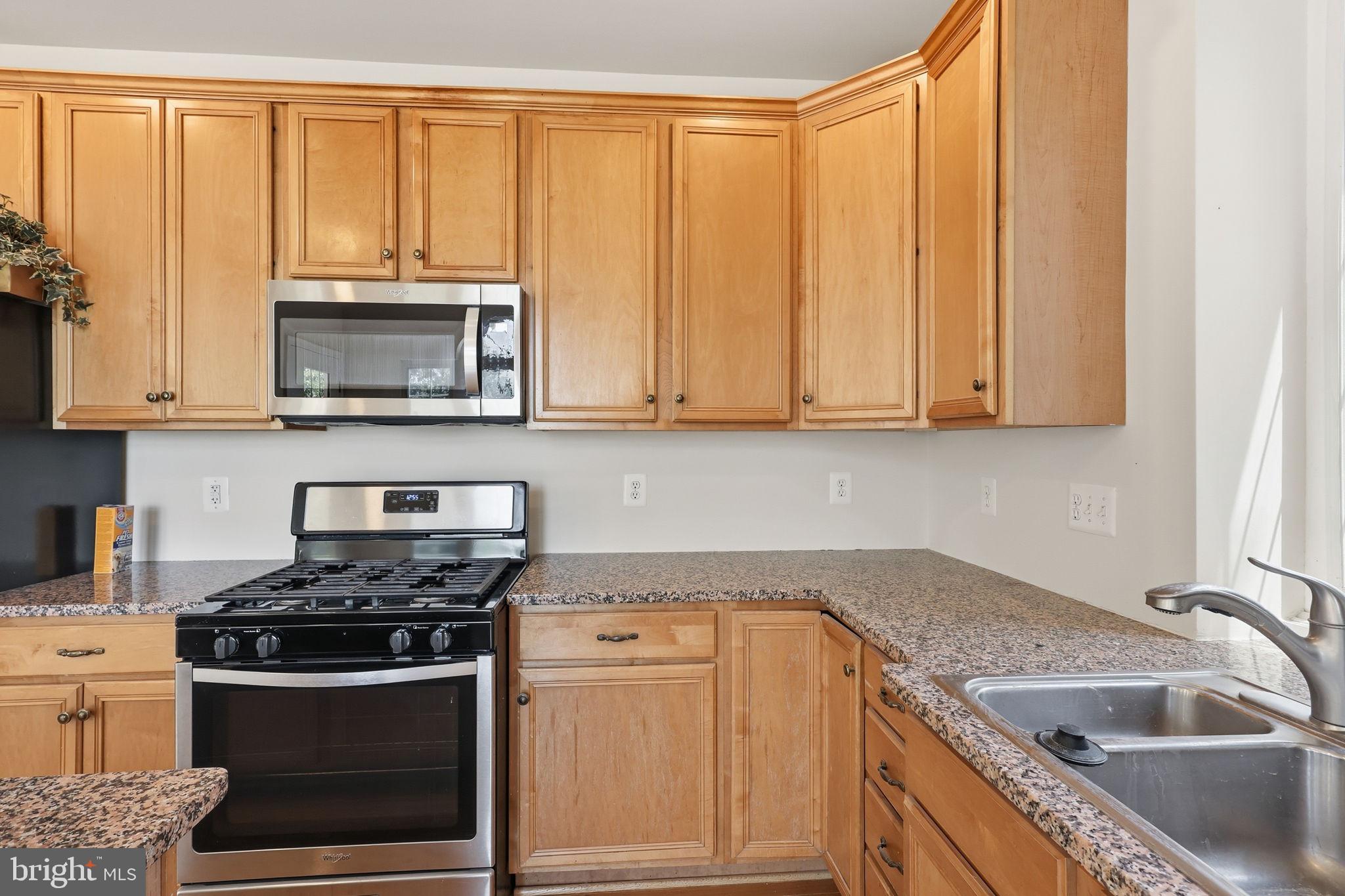 19617 Edgemont Square Ashburn, VA 20147 - Photo 23 of 65 a kitchen with granite countertop a sink stainless steel appliances and cabinets