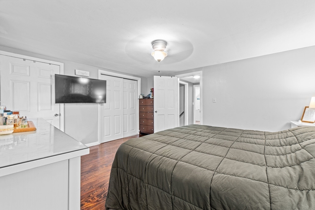 22 Eames Avenue Amherst, MA 01002 - Photo 16 of 36 a bedroom with a bed and a flat screen tv