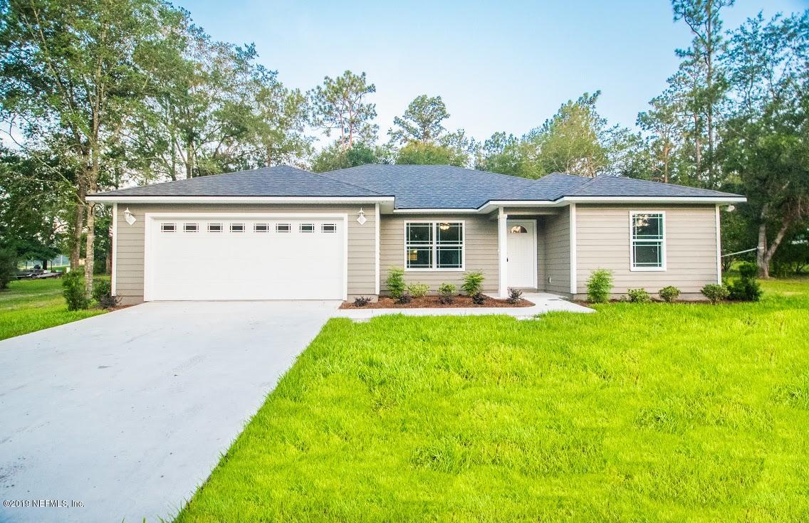 a view of backyard of house with outdoor seating and green space