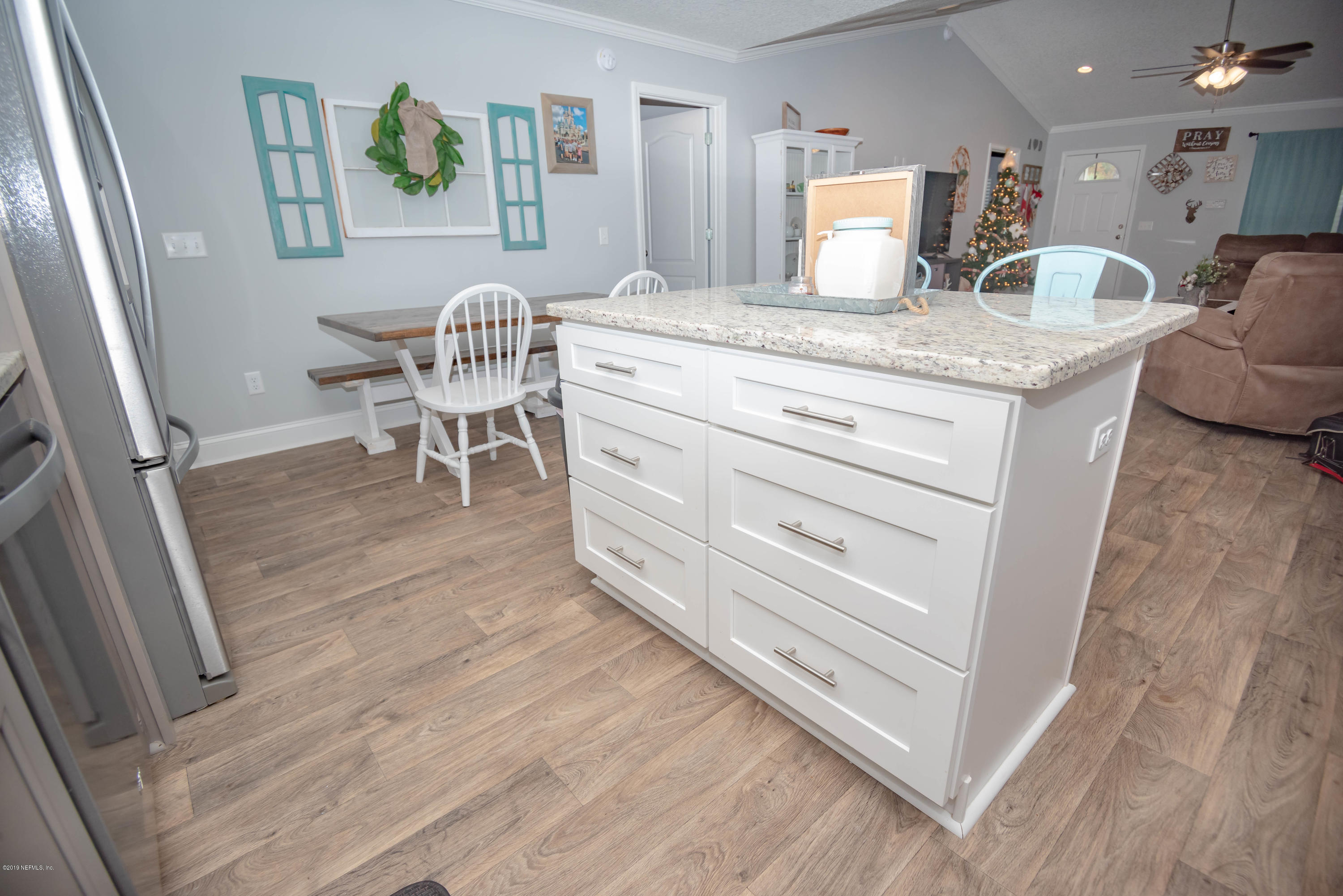 9964 River Oak Circle Glen St. Mary, FL 32040 - Photo 11 of 41 a living room with granite countertop furniture and a wooden floor