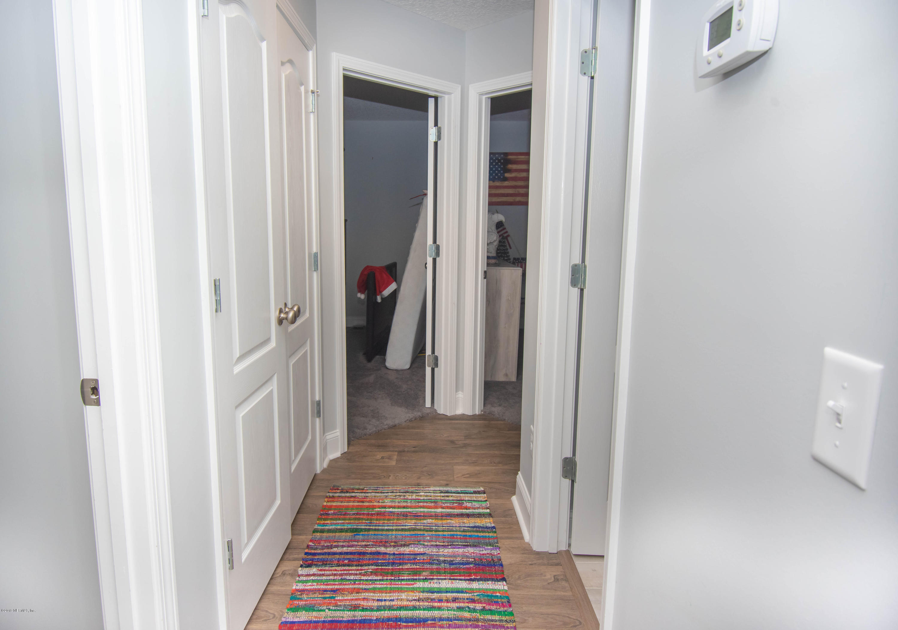 9964 River Oak Circle Glen St. Mary, FL 32040 - Photo 13 of 41 a view of a hallway with wooden floor and entryway