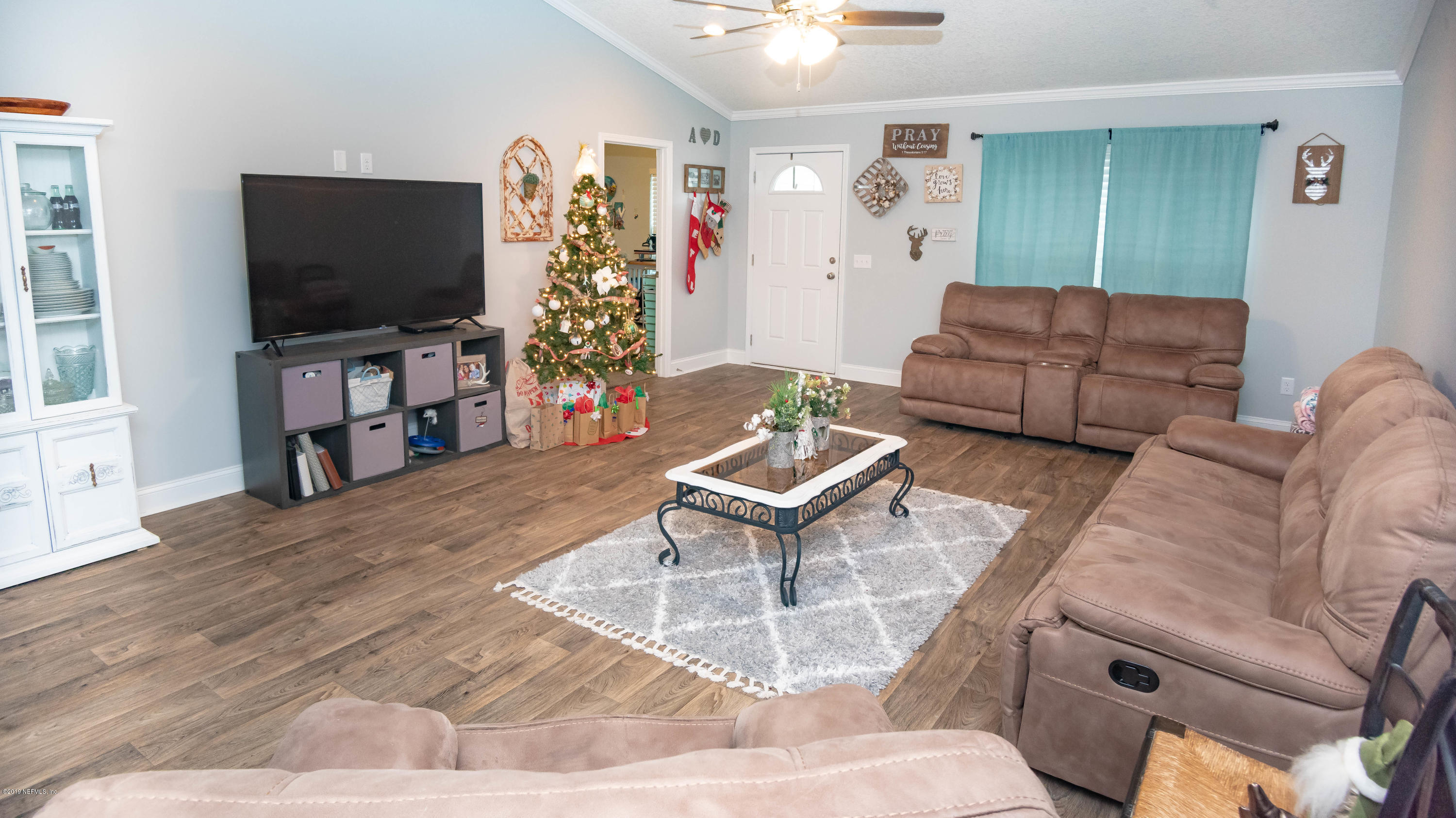 9964 River Oak Circle Glen St. Mary, FL 32040 - Photo 2 of 41 a living room with furniture and a flat screen tv