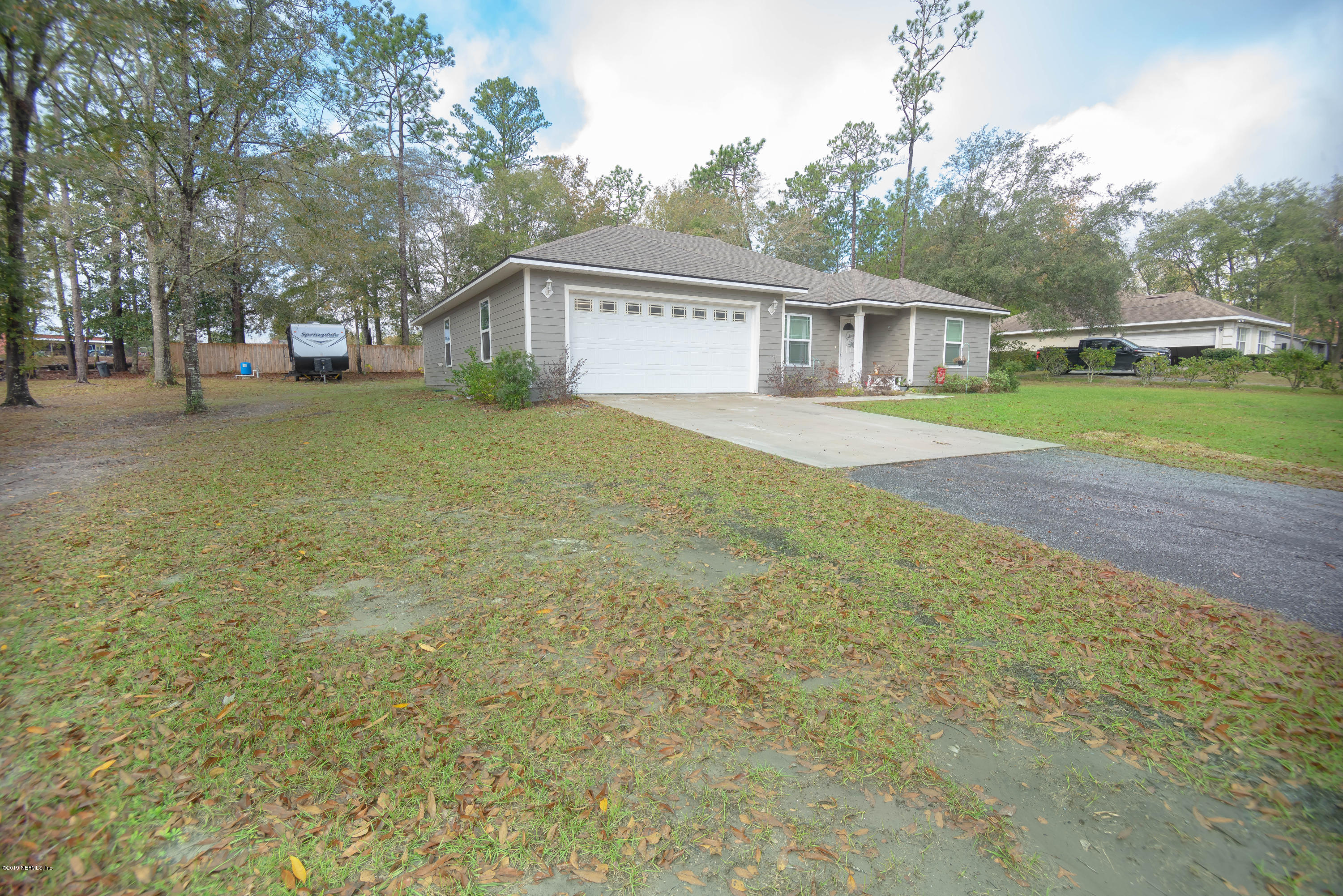 9964 River Oak Circle Glen St. Mary, FL 32040 - Photo 27 of 41 a front view of a house with a yard and trees