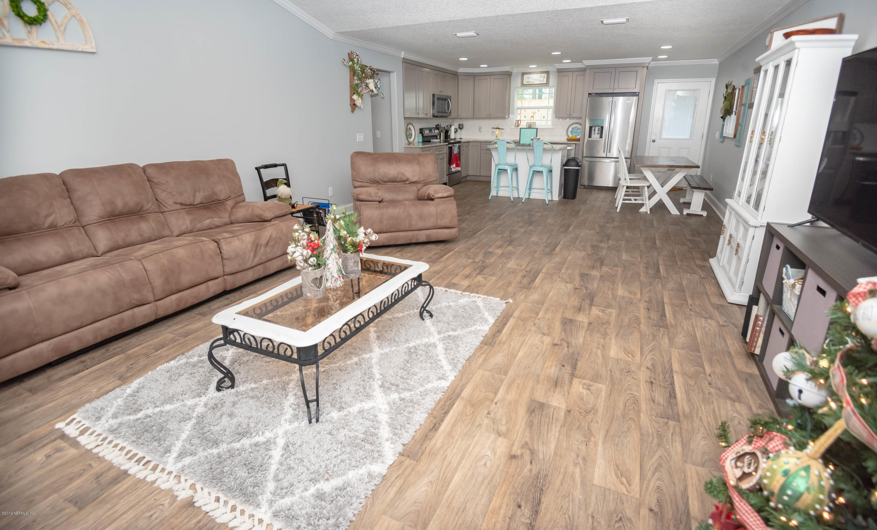 9964 River Oak Circle Glen St. Mary, FL 32040 - Photo 3 of 41 a living room with furniture and a flat screen tv