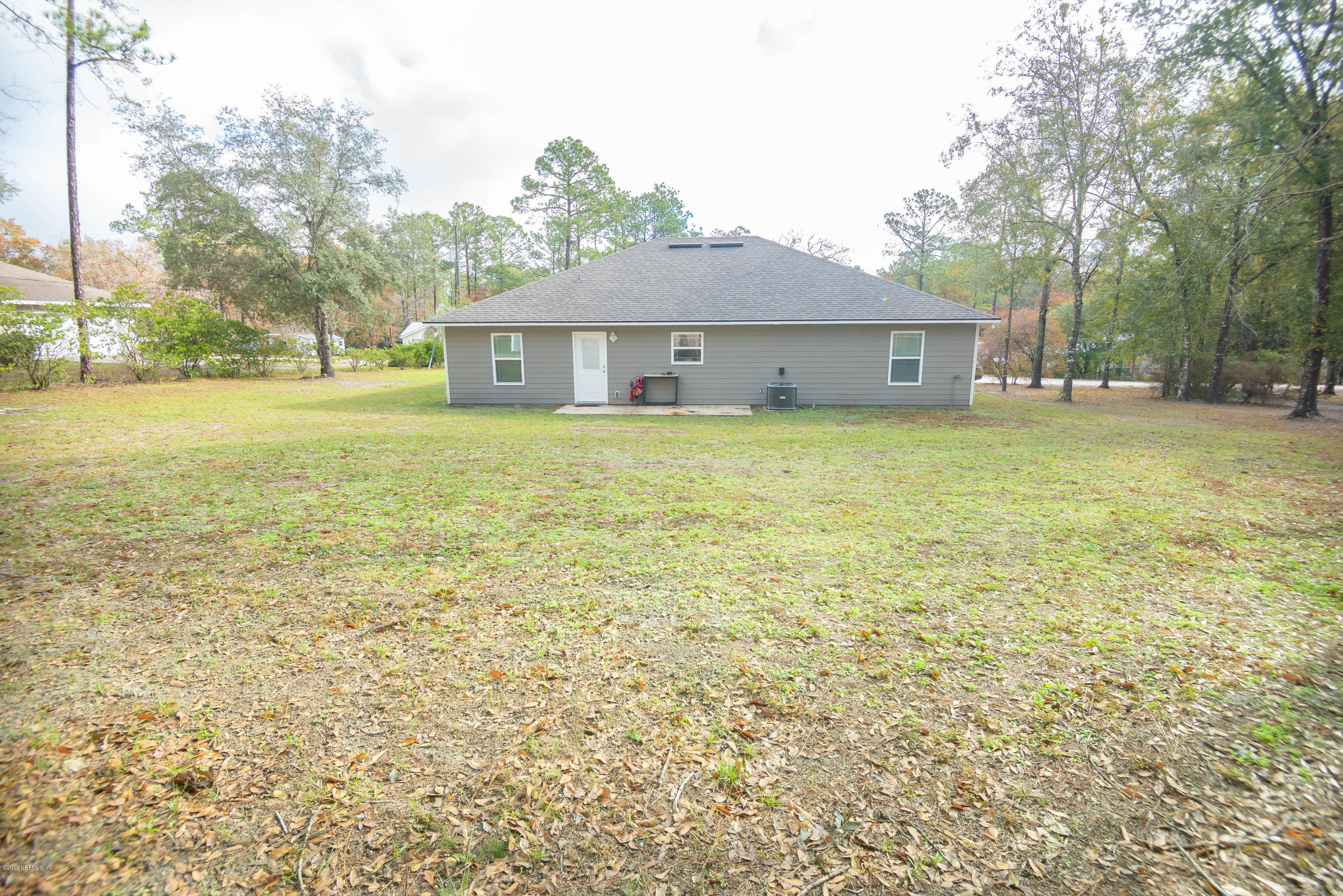 9964 River Oak Circle Glen St. Mary, FL 32040 - Photo 31 of 41 a front view of house with yard and trees