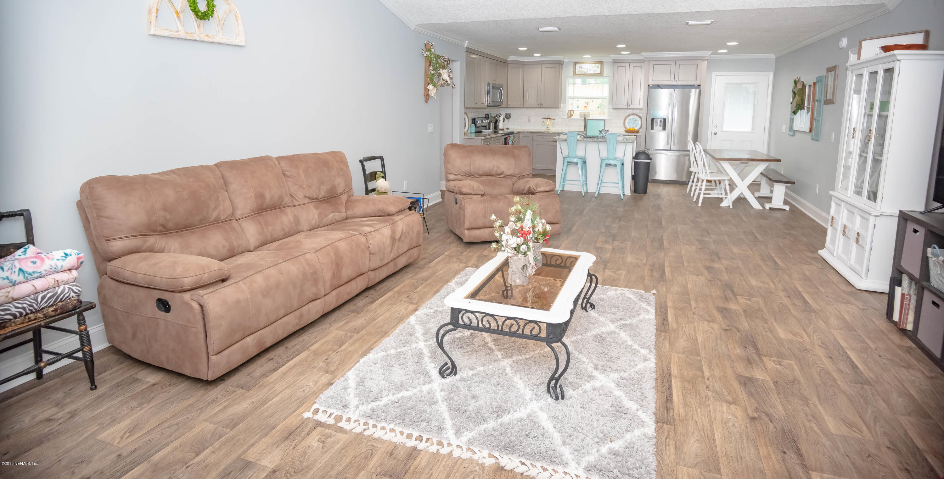 9964 River Oak Circle Glen St. Mary, FL 32040 - Photo 4 of 41 a living room with furniture and kitchen view with wooden floor