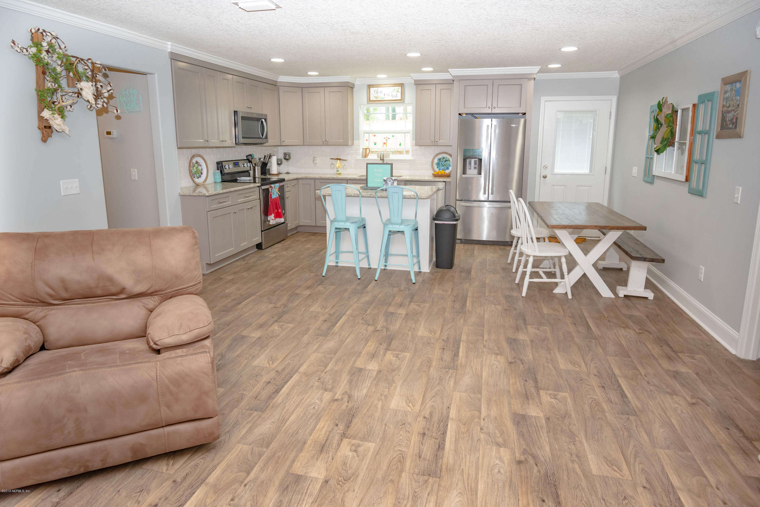 9964 River Oak Circle Glen St. Mary, FL 32040 - Photo 6 of 41 a living room with furniture and kitchen view
