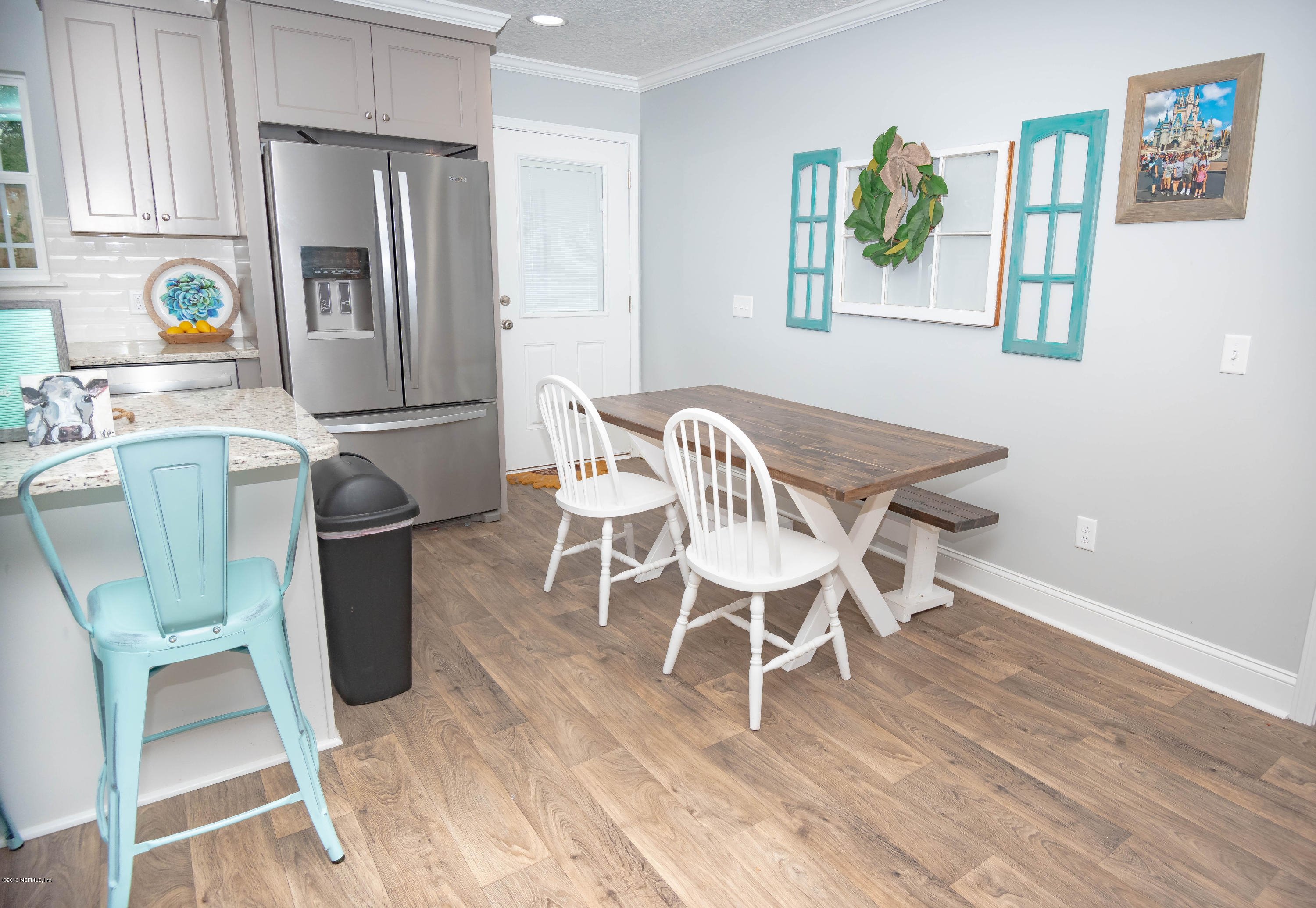 9964 River Oak Circle Glen St. Mary, FL 32040 - Photo 7 of 41 a view of a dining room with furniture a chandelier and wooden floor