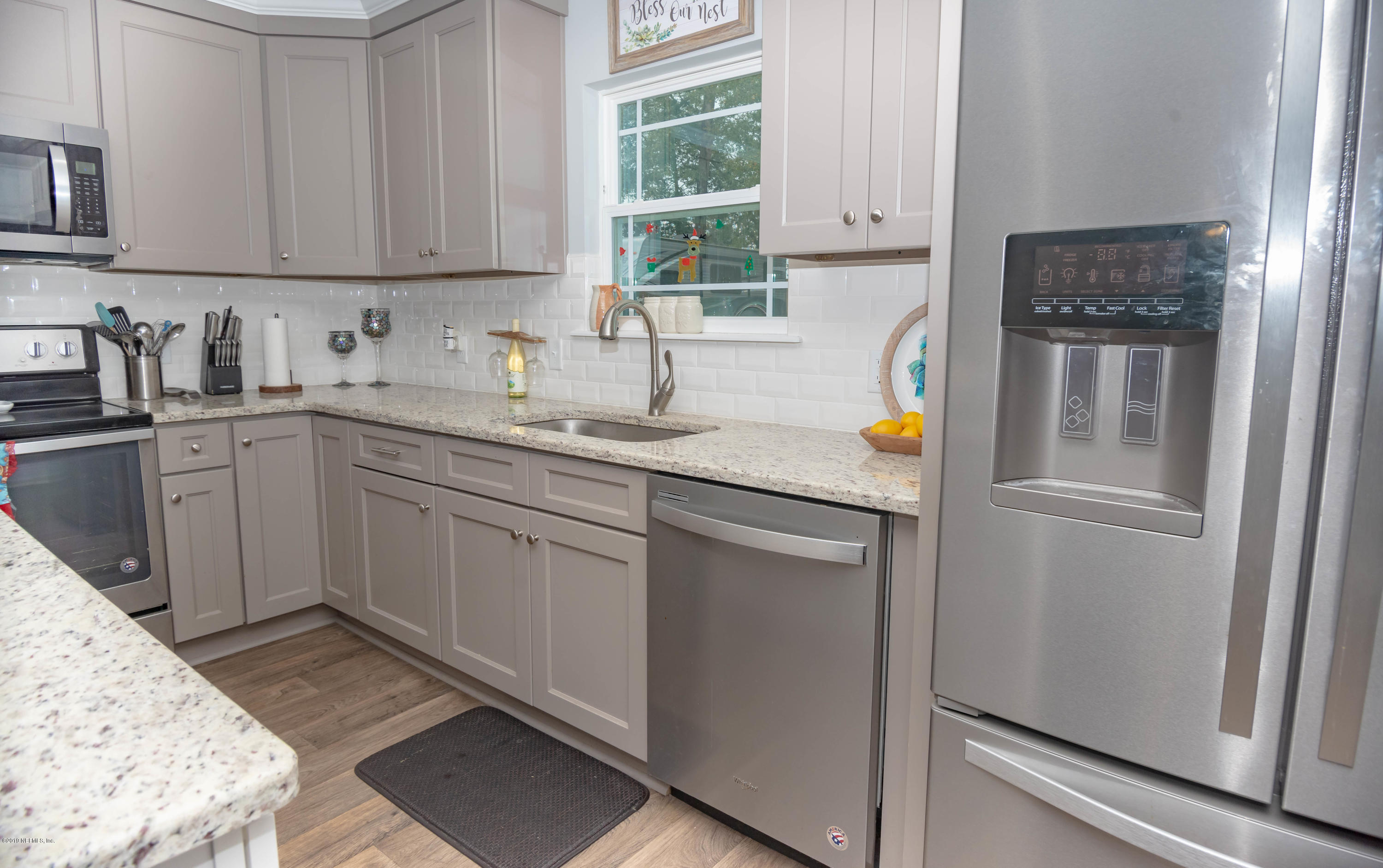 9964 River Oak Circle Glen St. Mary, FL 32040 - Photo 8 of 41 a kitchen with stainless steel appliances granite countertop a sink stove and refrigerator