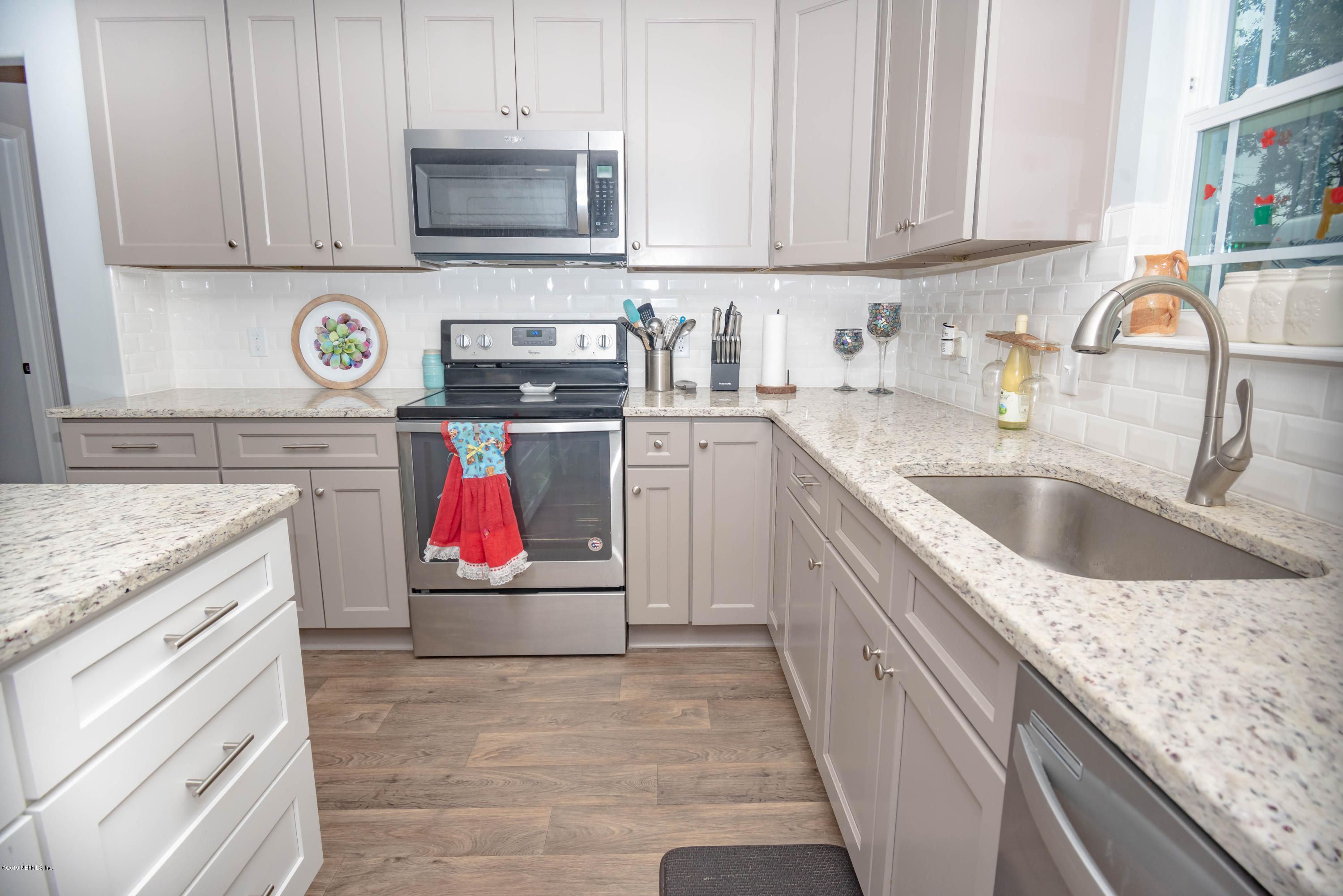 9964 River Oak Circle Glen St. Mary, FL 32040 - Photo 9 of 41 a kitchen with granite countertop a sink and a stove top oven