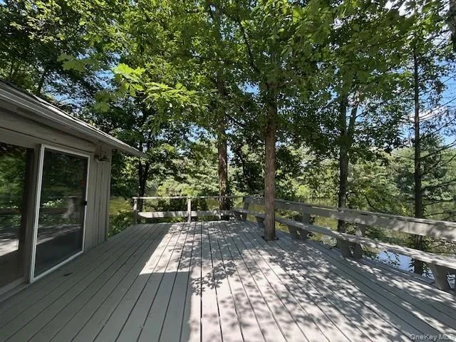 a view of backyard with table and chairs and wooden floor