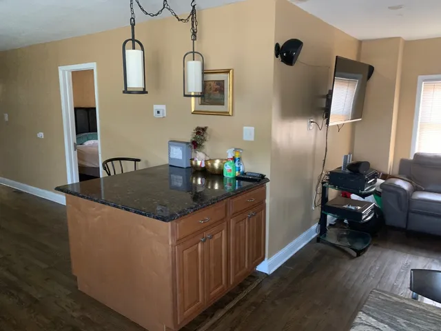 a kitchen with stainless steel appliances granite countertop a sink and a refrigerator