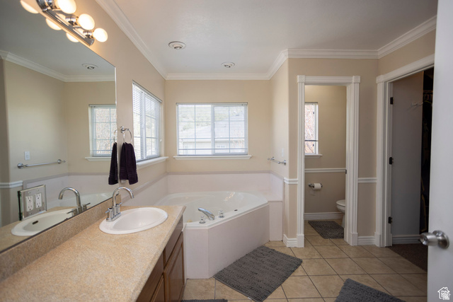 7532 North Castle Rock Road Eagle Mountain, UT 84005 - Photo 19 of 40 Primary Bedroom Full bathroom featuring vanity, light tile patterned floors, a garden tub, and ornamental molding