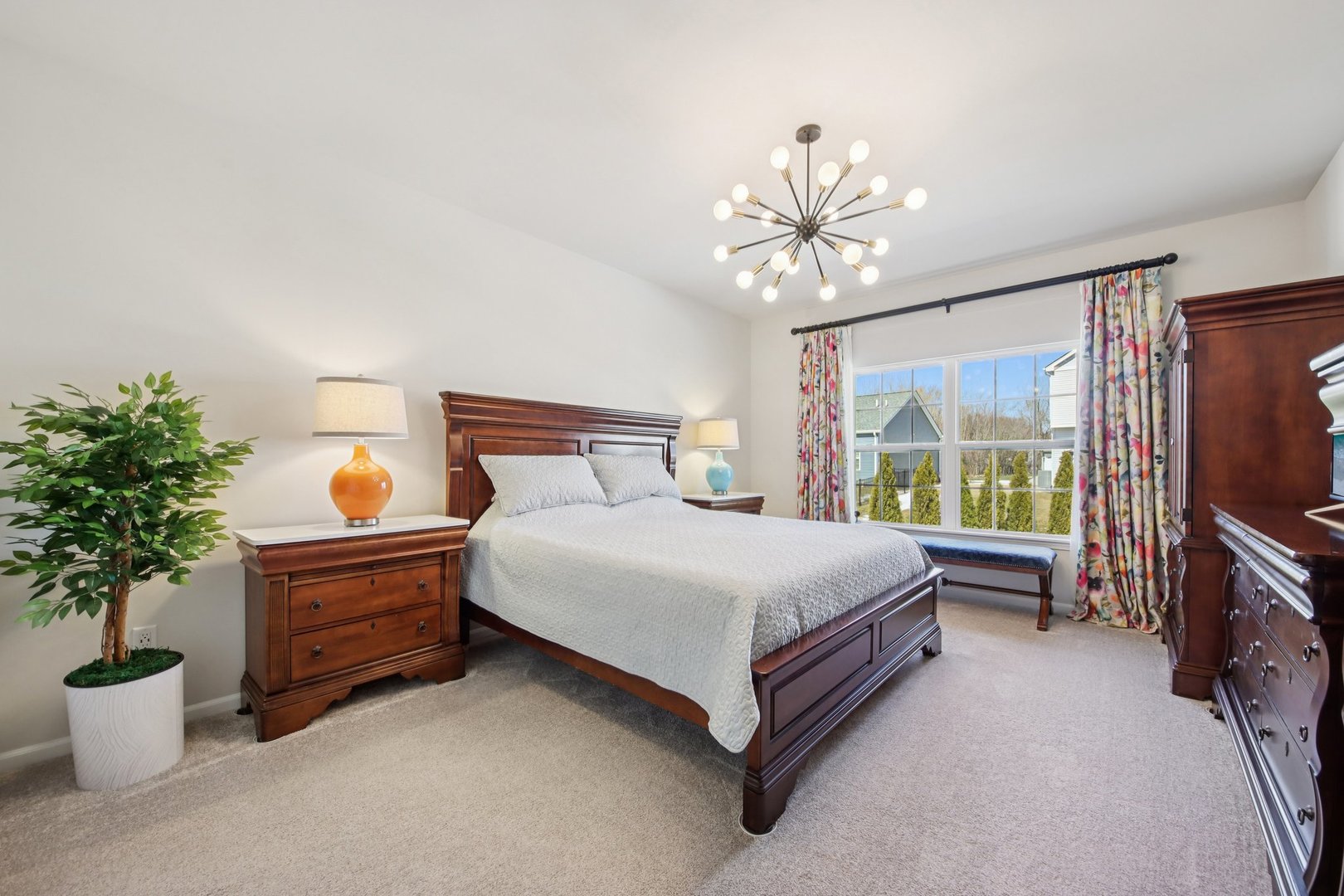 429 Fairway Lane Sycamore, IL 60178 - Photo 12 of 43 a bedroom with a bed potted plant on the dresser and a chandelier