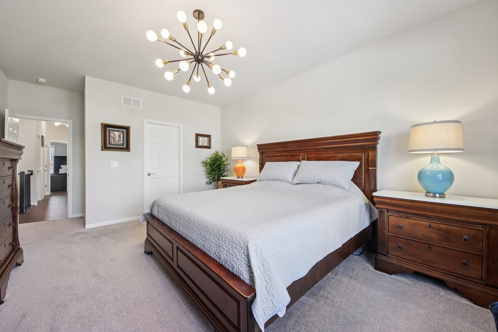 429 Fairway Lane Sycamore, IL 60178 - Photo 13 of 43 a bedroom with a bed and a chandelier