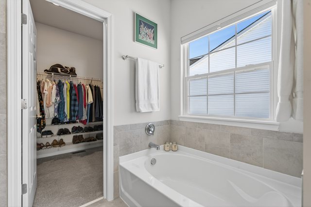 429 Fairway Lane Sycamore, IL 60178 - Photo 16 of 43 a bathroom with a tub a sink and a window