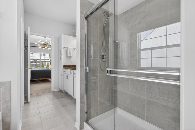 429 Fairway Lane Sycamore, IL 60178 - Photo 17 of 43 a bathroom with a shower and a glass door