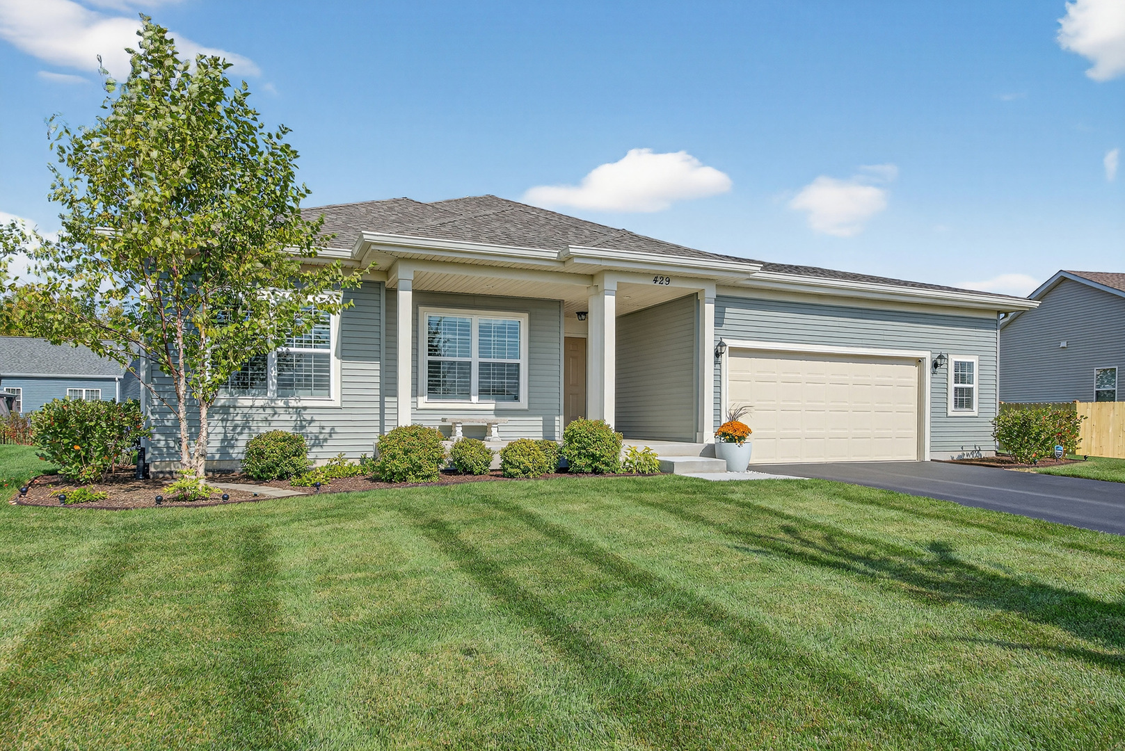 429 Fairway Lane Sycamore, IL 60178 - Photo 39 of 43 a front view of a house with a yard and garage