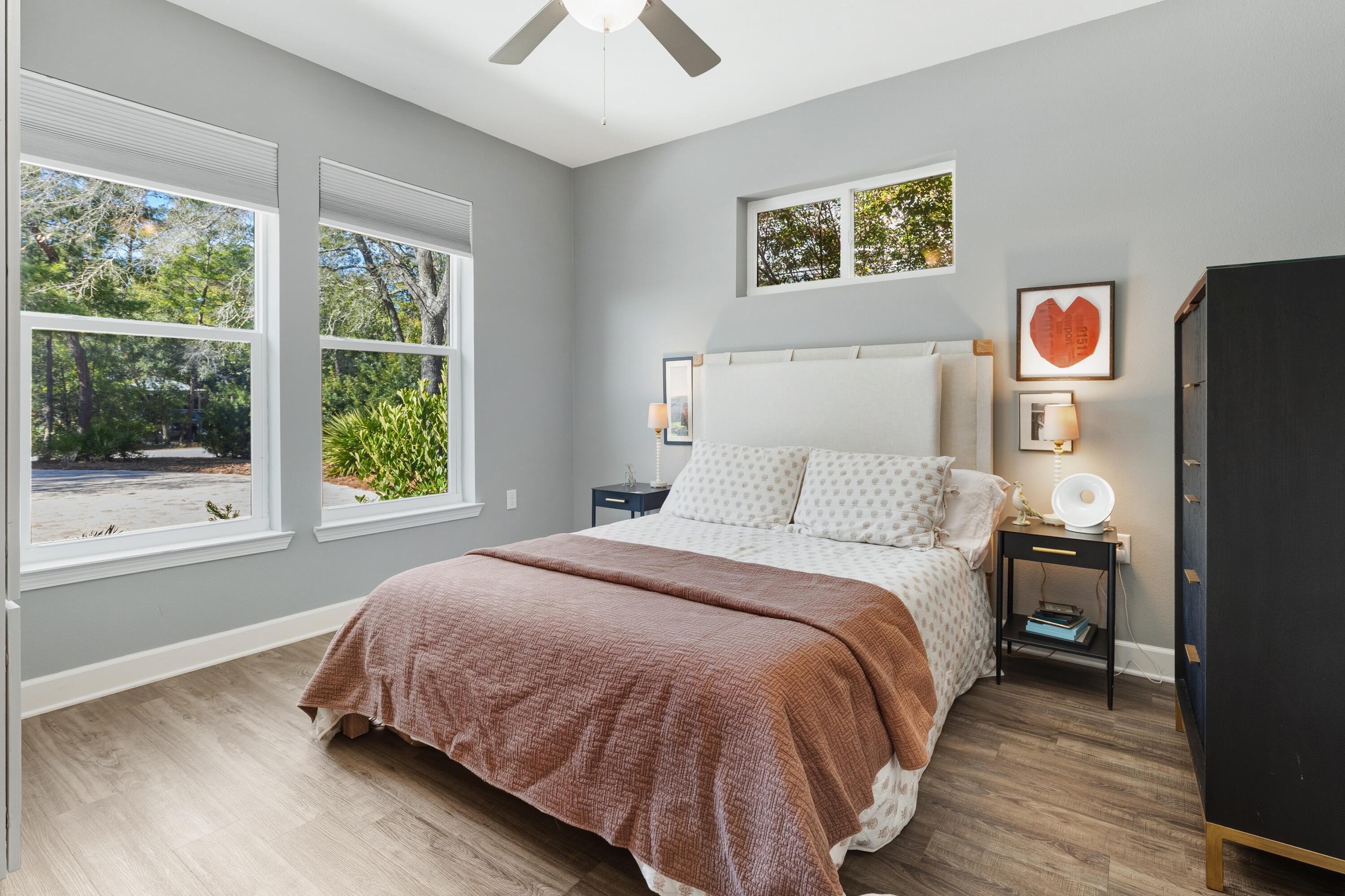 448 Ricker Avenue Santa Rosa Beach, FL 32459 - Photo 14 of 30 a spacious bedroom with a bed and wooden floor