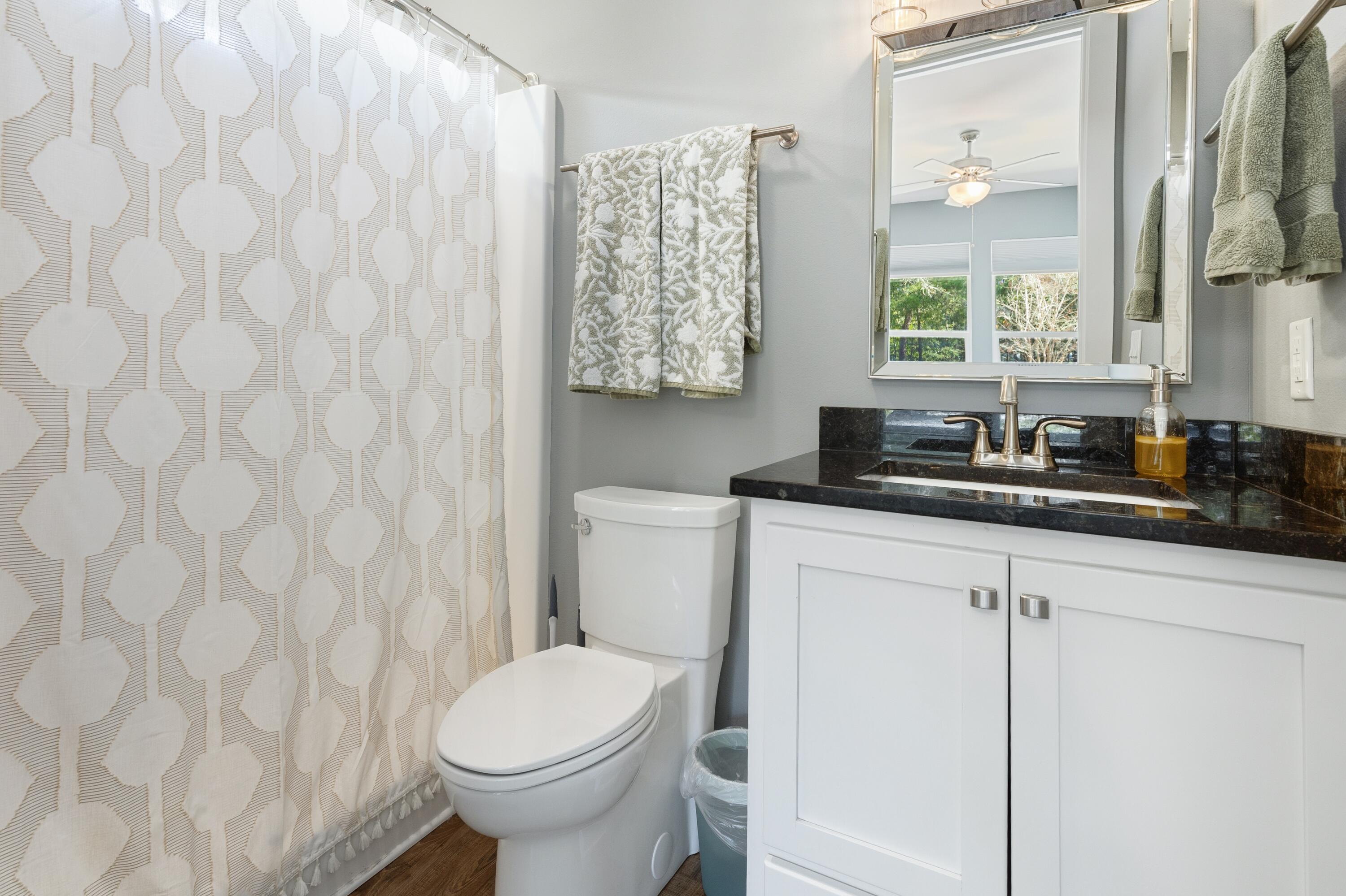 448 Ricker Avenue Santa Rosa Beach, FL 32459 - Photo 16 of 30 a bathroom with a granite countertop sink and a toilet