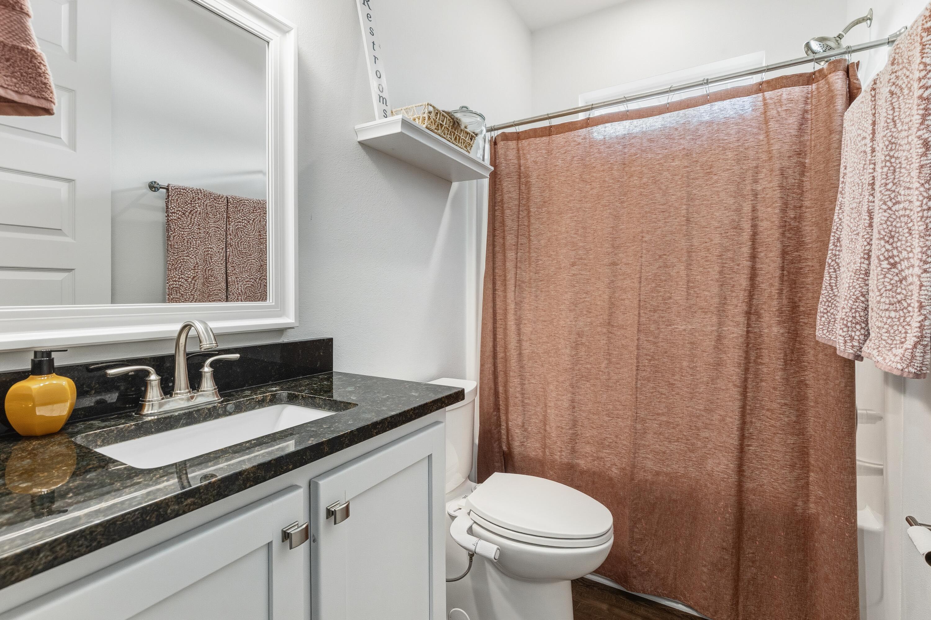 448 Ricker Avenue Santa Rosa Beach, FL 32459 - Photo 18 of 30 a bathroom with a granite countertop sink and a mirror