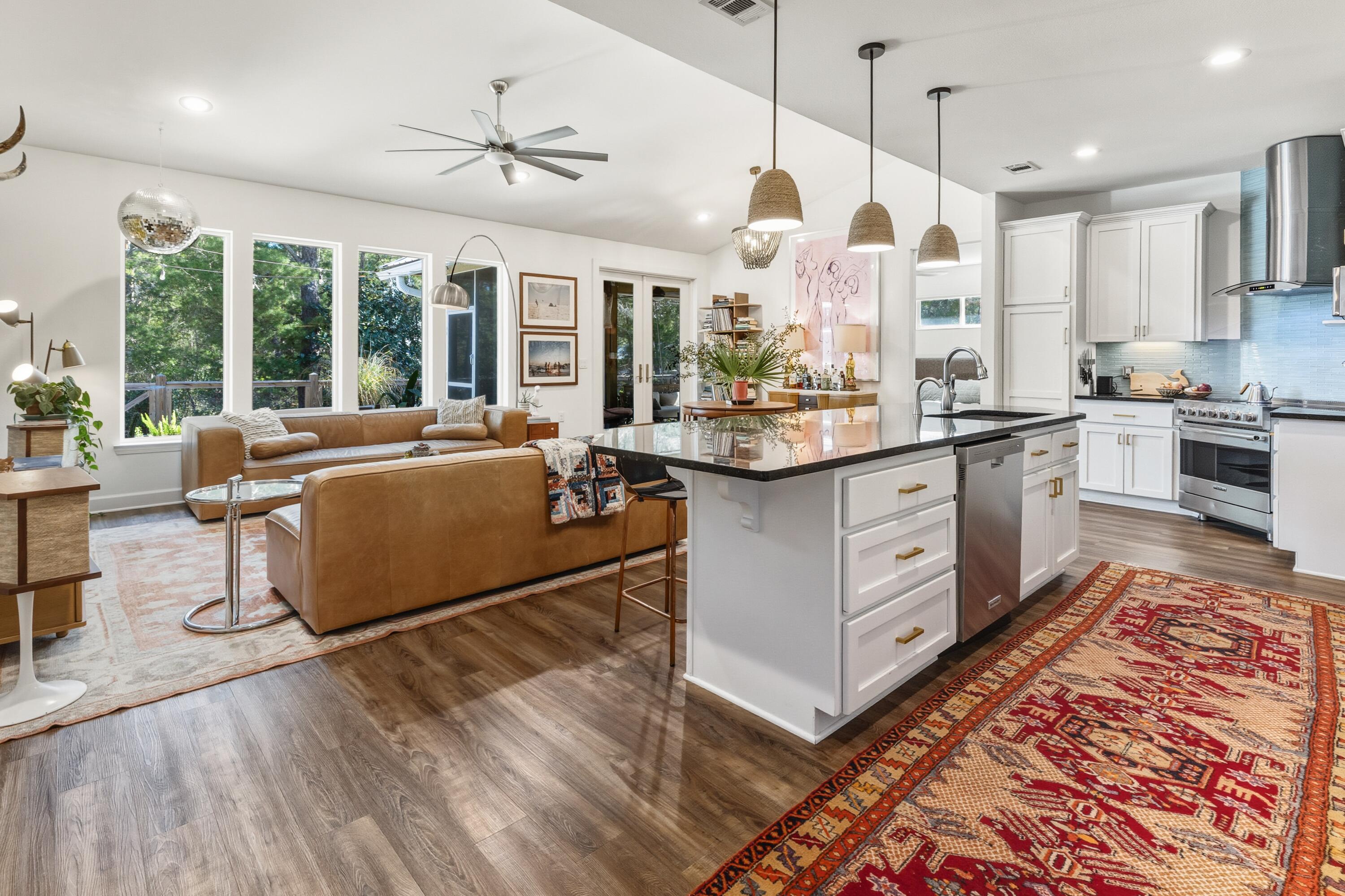 448 Ricker Avenue Santa Rosa Beach, FL 32459 - Photo 2 of 30 a large kitchen with kitchen island a large counter top space a sink and stainless steel appliances