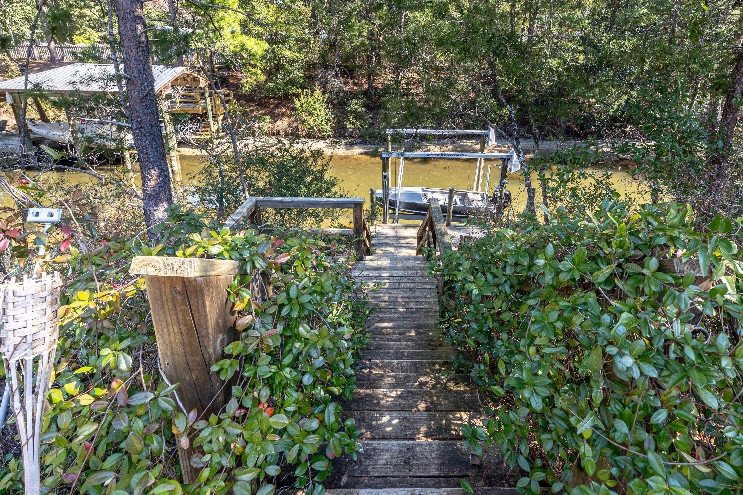 448 Ricker Avenue Santa Rosa Beach, FL 32459 - Photo 23 of 30 a view of a swimming pool with a patio and garden