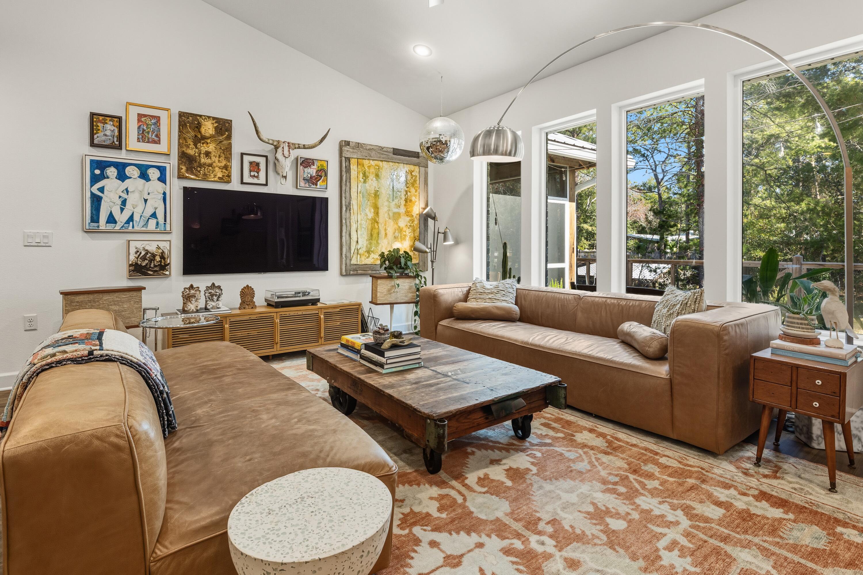 448 Ricker Avenue Santa Rosa Beach, FL 32459 - Photo 4 of 30 a living room with furniture a flat screen tv and a large window